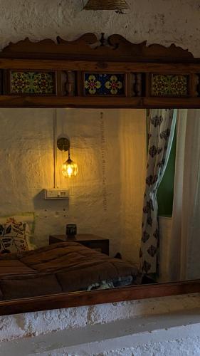a reflection of a bedroom with a bed in a mirror at Finding Clover in Banjār
