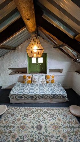 a bedroom with a bed with a green window at Finding Clover in Banjār