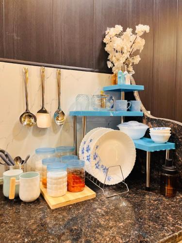a counter top with bowls and other kitchen utensils at Ophelia in Agra