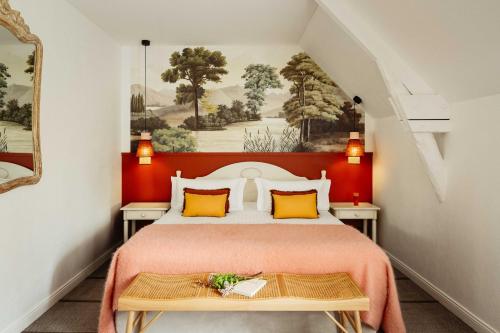 a bedroom with a large bed with a red headboard at Hôtel & Spa de La Bretesche in Missillac