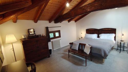 a bedroom with a large bed and a chair at La Torre di Longara in Calderara di Reno