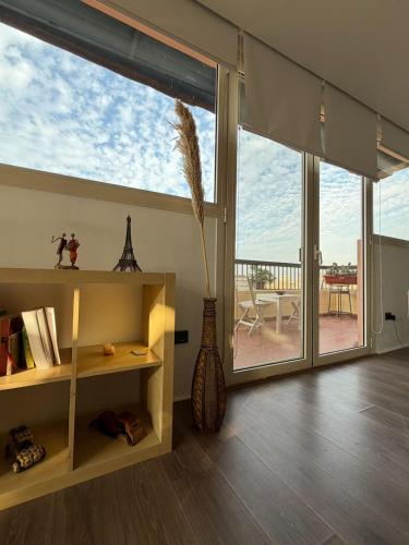 a living room with a large window and a vase at Zenith Cairo Deluxe Room Shared Apartment in Cairo