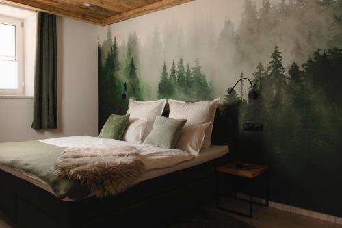a bedroom with a bed with a painting on the wall at Chalet Ferienwohnung zwischen Berchtesgaden und Ramsau in Bischofswiesen