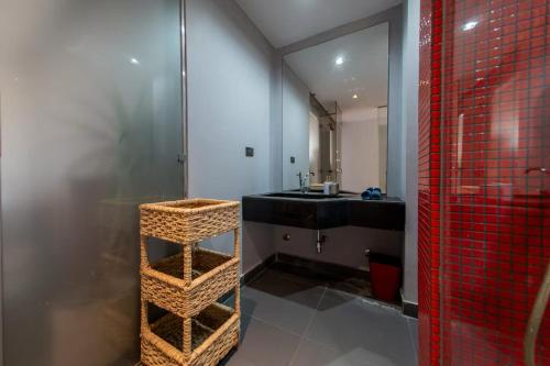 a bathroom with a shower and a black sink at Zenith Cairo Deluxe Room Shared Apartment in Cairo