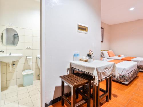 a hotel room with a bed and a bathroom at California Signature Suites in Sudtungan