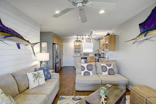 a living room with a couch and a ceiling fan at Bay Tree A3 in Port Aransas