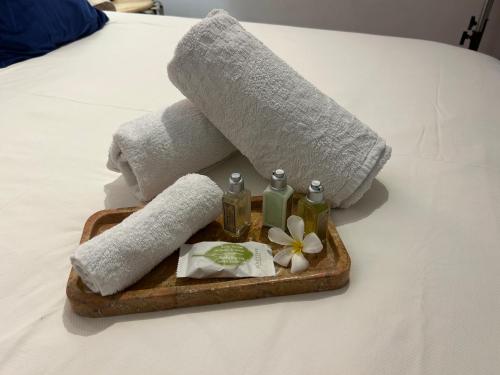a tray with towels and spa items on a bed at Whitfords Garden Retreat in Perth