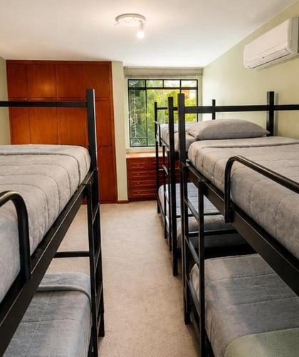a row of bunk beds in a room at Bergamota Hostel in Curitiba