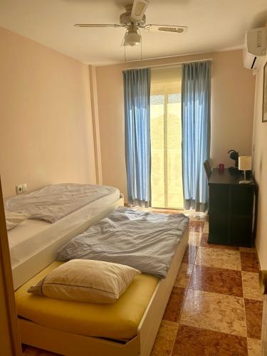 a bedroom with two bunk beds and a window at Casa Marta in Beniarjó