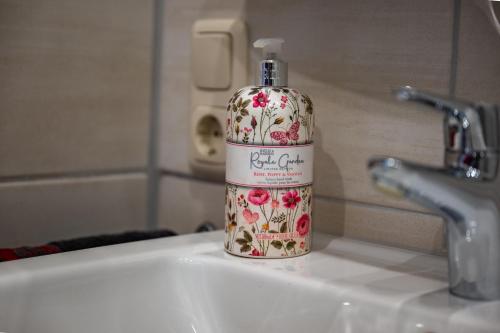 a bottle of soap sitting on top of a sink at Gästehaus Wolfgang Taubensee in Ruhpolding