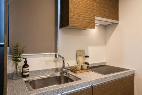 a kitchen with a sink and a counter top at Seoul Ahava Hotel in Seoul