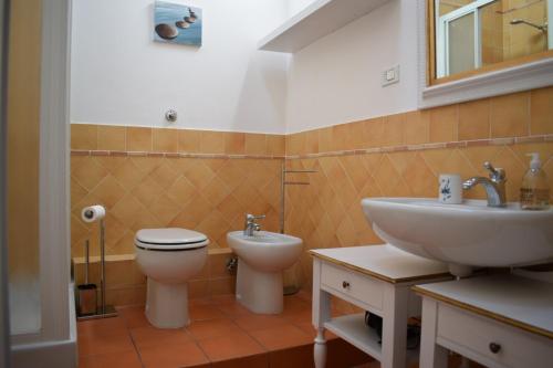 a bathroom with a toilet and a sink at Martini River House in Barberino di Mugello