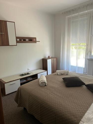 a bedroom with a bed with a sink and a window at Mokka Home in Békéscsaba