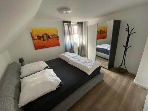 a bedroom with two beds and a mirror at Haus Dani in Oldenburg in Holstein