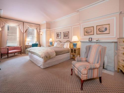 a bedroom with a bed and a chair at La Reserve On Pine in Philadelphia