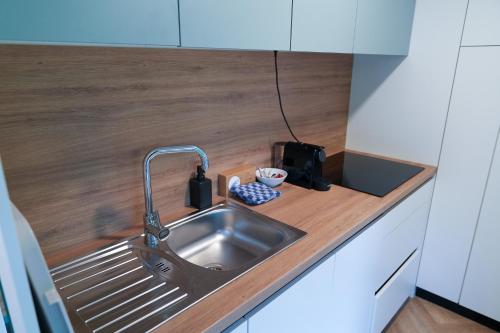 a kitchen sink with a faucet on a counter at Urban Gardens Ieper in Ieper