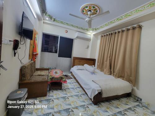 a bedroom with a bed in a room with a ceiling at Hotel Zamzam Residential in Dhaka