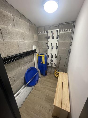 a baseball dugout with a wooden bench in a room at Duplex T4 residence les Etoiles du Sud in Le Lioran