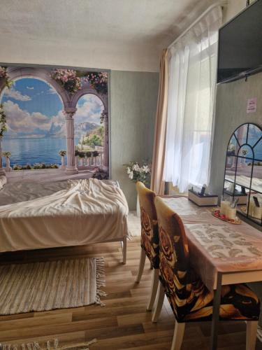 a bedroom with a bed and a table and a window at Ivory & Rose Studio in Tartu