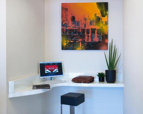 a desk with a computer on top of it at My One Hotel Bologna in Bologna