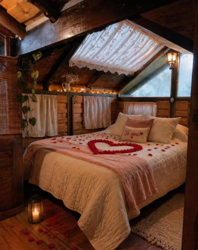 a bedroom with a bed in a room with a roof at Cabaña en la Calera con Sauna in La Calera