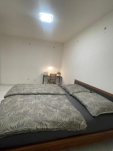 a bedroom with a bed and a table in it at U Tonyho - Apartmán v centru Strakonice 2-kk in Strakonice