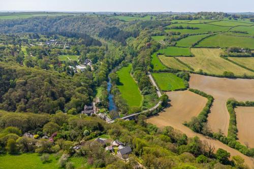 an aerial view of a village with a river and fields at Brynor Lodge in Great Torrington