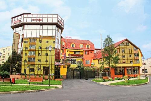 a group of buildings in front of a street at Hotel Tiver in Câmpia Turzii