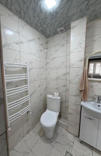 a bathroom with a toilet and a sink at Guest House in Gyumri in Gyumri