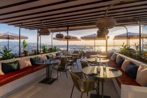 a restaurant with tables and chairs and umbrellas at Catalonia Majórica in Palma de Mallorca