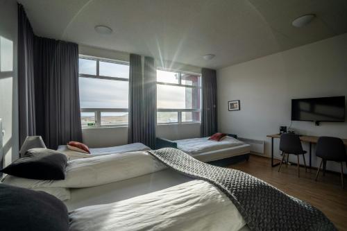 a hotel room with two beds and a window at Volcano Hotel in Vík