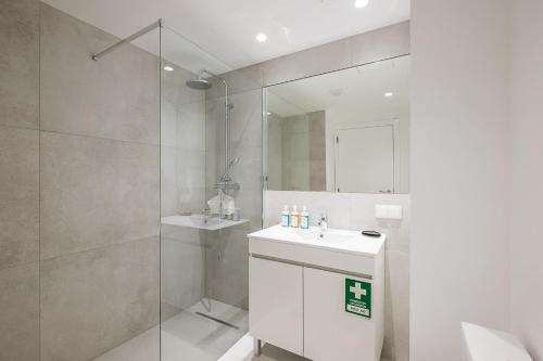 a bathroom with a white sink and a shower at #081 1BR Vale Mangude Pool & Location in Albufeira