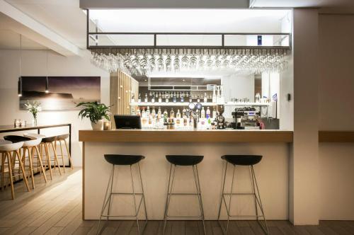 a bar in a kitchen with bar stools at Storm Hotel by Keahotels in Reykjavík