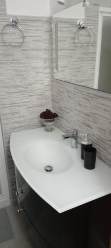 a bathroom with a white sink and a mirror at B&B Ca' d'Andrea in San Martino