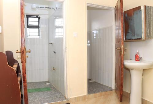 a bathroom with a sink and a toilet at Karani Suites in Nyahururu
