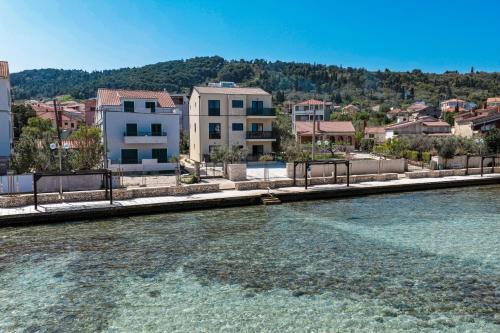 a body of water next to a city with buildings at Villa Vita Mare in Preko