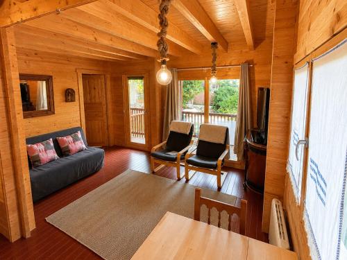 a living room with a couch and chairs and a television at Casa rural 'La Huerta' in Rascafría