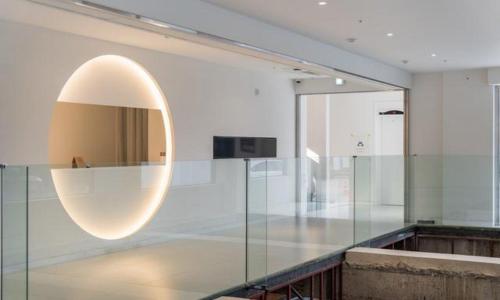 a room with a glass wall with a mirror at Bluefrog Hotel in Incheon