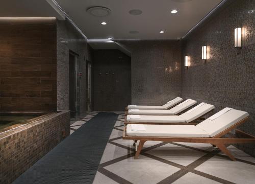a row of white lounge chairs in a lobby at Hotel Borg by Keahotels in Reykjavík