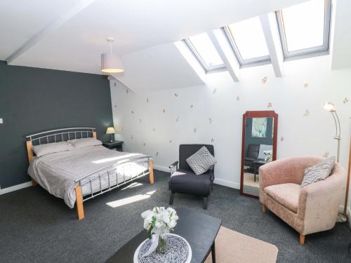 a bedroom with a bed and a chair and a table at Apartment 2 in Aberdeen