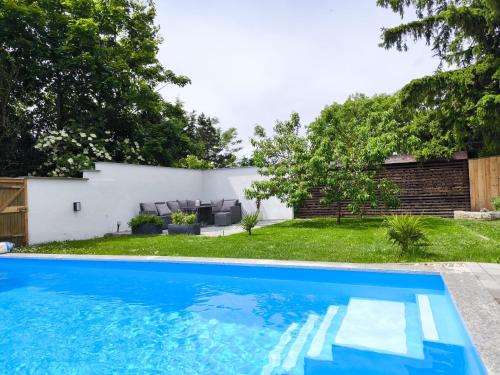 a swimming pool in the backyard of a house at Ferienhaus Isabel in Gernrode - Harz