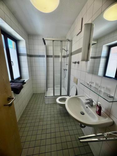 a bathroom with a sink and a shower at Neros Hotel in Siegenburg