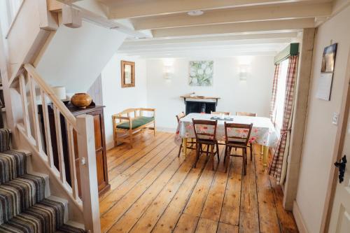 a dining room with a table and some chairs at Kathleen's Croft, charming detached croft house in Torridon