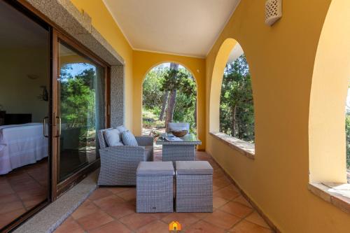a living room with yellow walls and windows at Villa Teresa Simius Beach Front in Simius