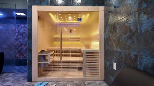 a shower stall in a room with a wall at Airfield Hotel & Spa in Vibo Valentia