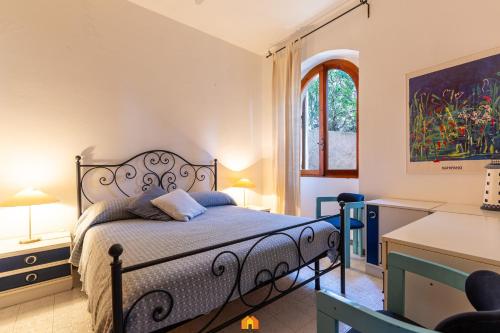 a bedroom with a bed and a window at Villa Teresa Simius Beach Front in Simius
