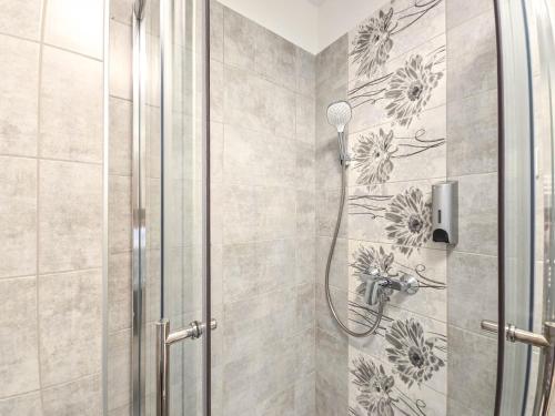 a shower in a bathroom with a shower at Trend Apartman in Bük