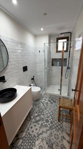a bathroom with a tub and a sink and a shower at Mirador de los Tejados in Alcalá del Júcar