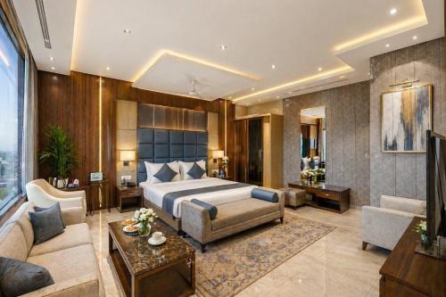 a bedroom with a bed and a living room at Hotel Wilkisto By Amar Singh Near Taj Mahal in Agra