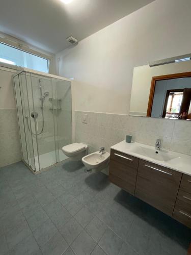 a bathroom with a shower and a sink and a toilet at Casa dell'OCA in Viganò